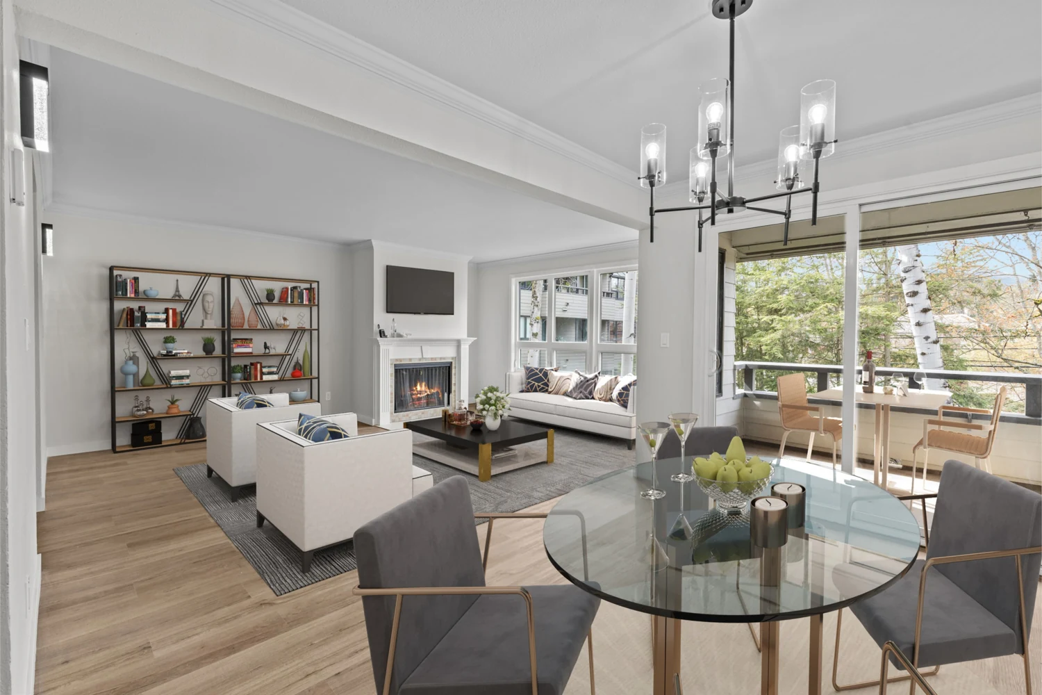 Finished dining area looking toward the furnished living room, fireplace, and balcony in the North Seattle condo